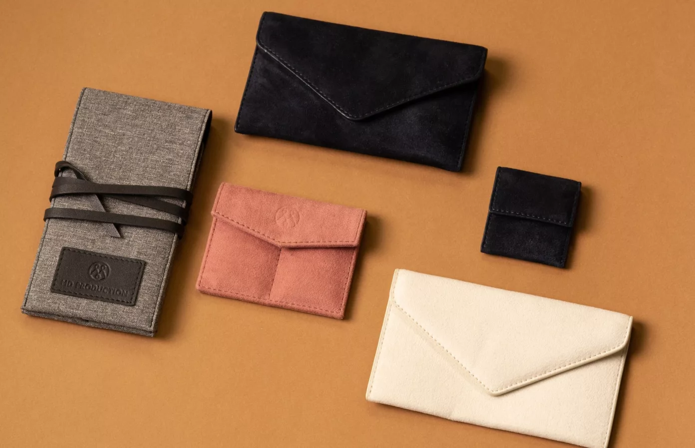 Service pouches in black, pink and cream suedette and a grey case with a cord tie, bespoke watch accessories, Maison Maëstra