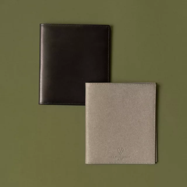 Two flat warranty card holders in smooth black leather and grained grey material, bespoke for watches