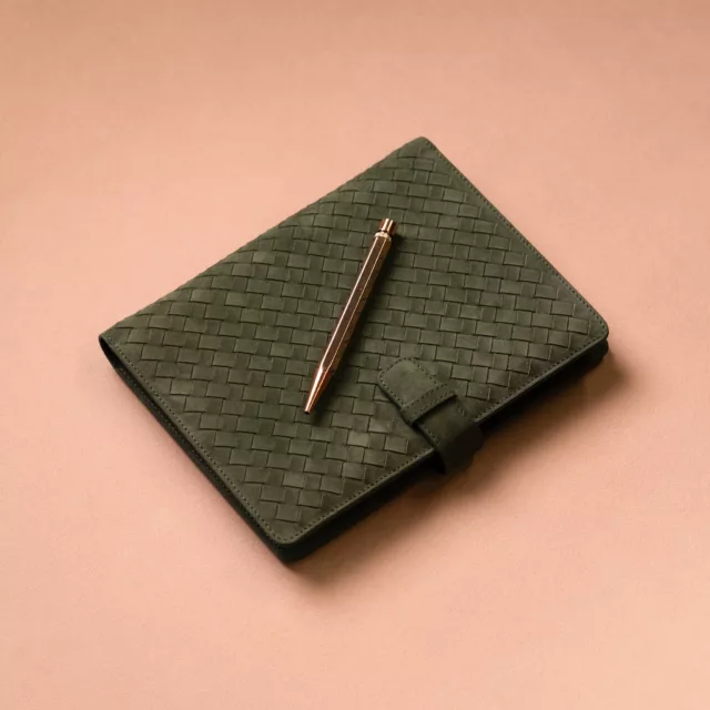 Green woven leather notebook with a closure tab and copper pen, bespoke corporate leather gift