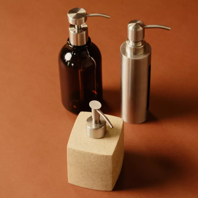 Amber glass, brushed steel and stone-effect pump dispensers for luxury hotel toiletries
