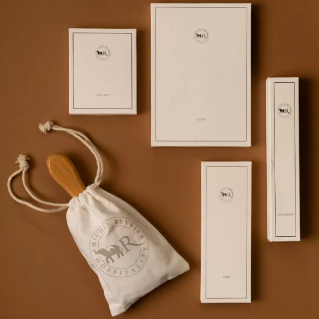 Ivory boxes for toothbrush, comb and loofah, wooden brush in a cotton pouch, bespoke vanity kit for a luxury hotel