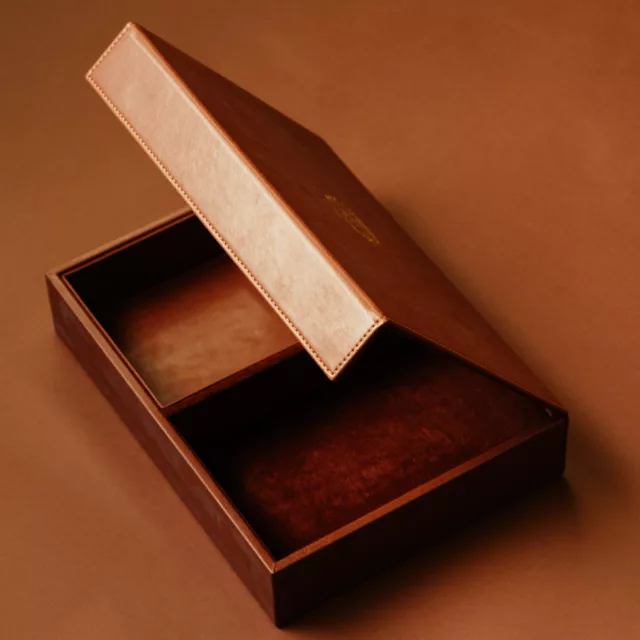 Open tan leather box with stitched lid and two lined compartments, bespoke guest room accessories for luxury hotels