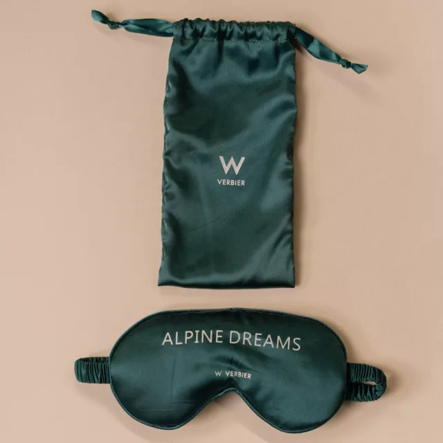 Forest-green satin sleep mask and drawstring pouch, a turndown gift among bespoke guest room accessories